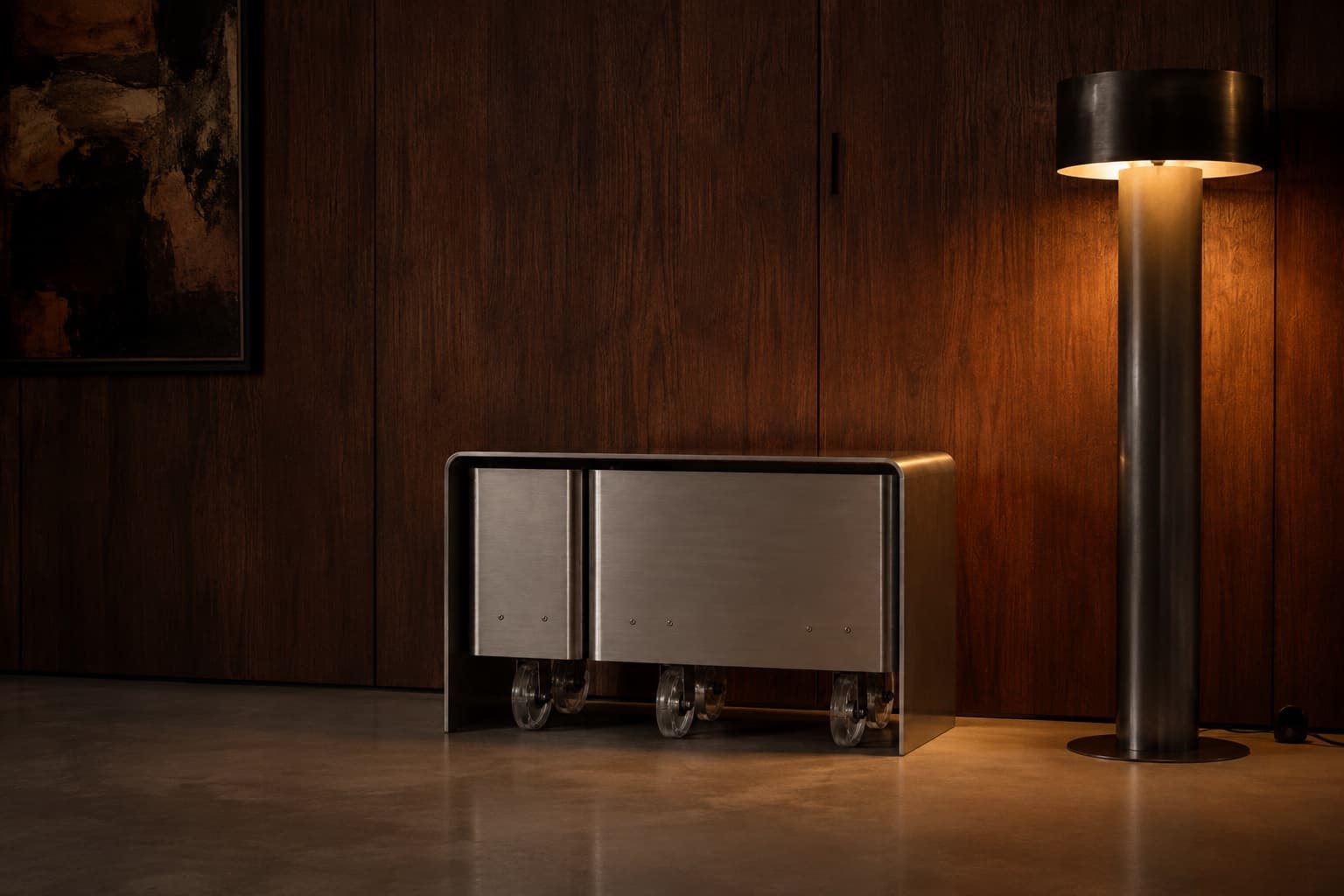 The cart at night beside a floor lamp, against dark wood panelling, its clear casters showing